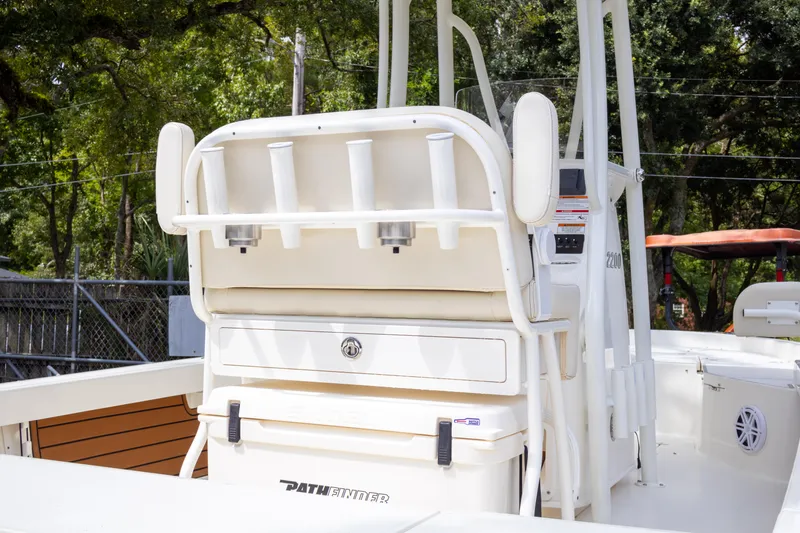 Slide: The Image of 2025 Pathfinder 2200 TRS boat with rod holders and storage, docked outdoors. - 9