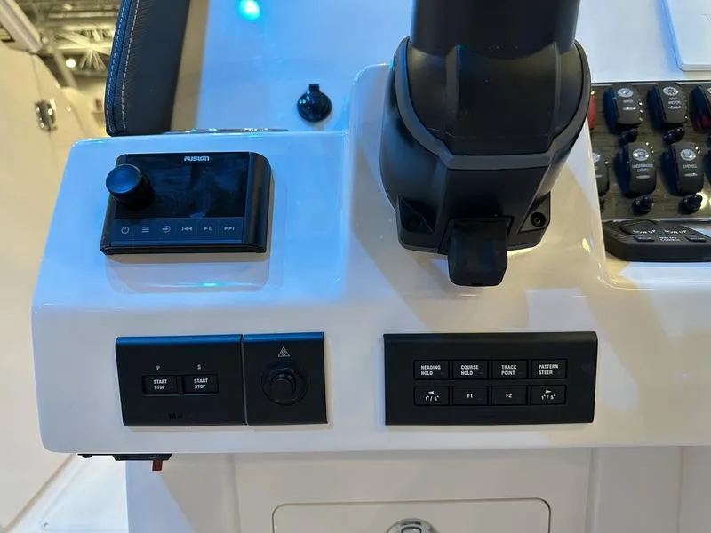 Slide: The Image of Control panel of 2025 Grady-White Freedom 275 boat with various switches and controls. - 11
