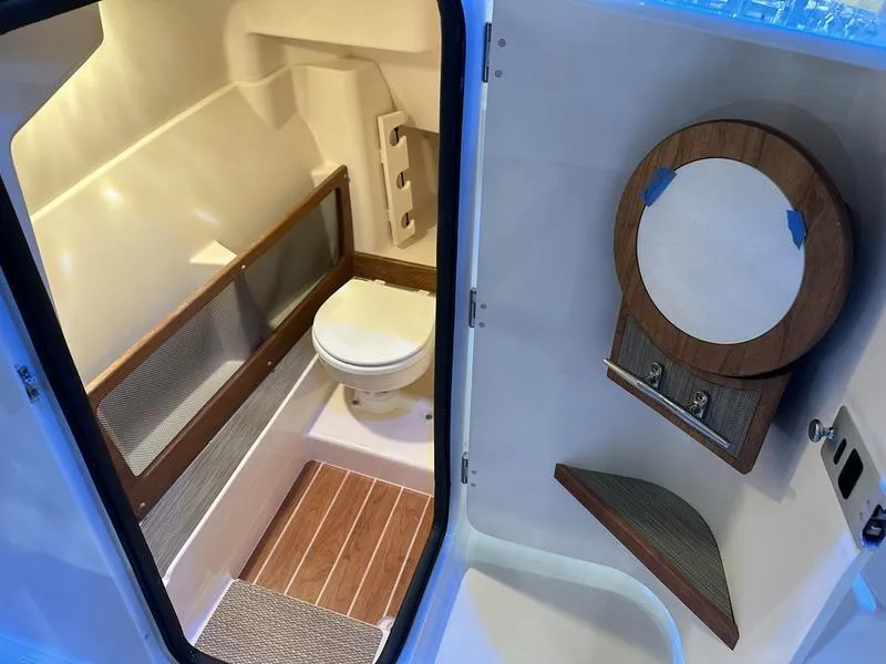 Slide: The Image of 2025 Grady-White Freedom 275 boat interior with modern bathroom amenities. - 13