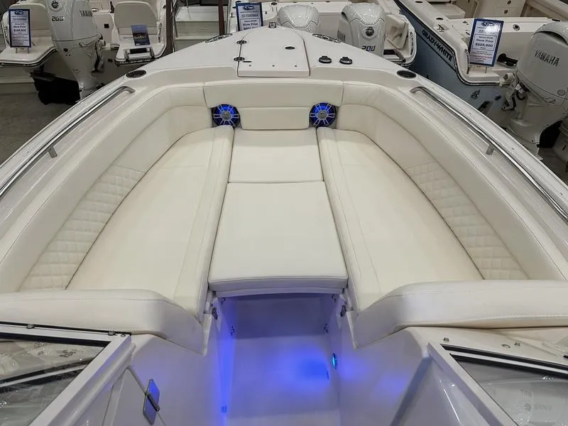 Slide: The Image of 2025 Grady-White Freedom 275 boat interior with white seating and blue LED lighting. - 14
