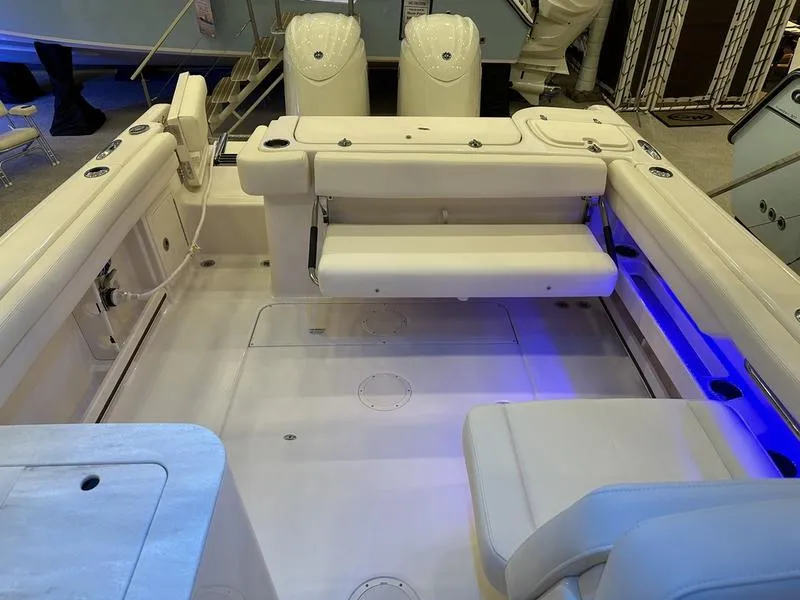 Slide: The Image of 2025 Grady-White Freedom 275 boat interior with seating and blue LED lighting. - 5