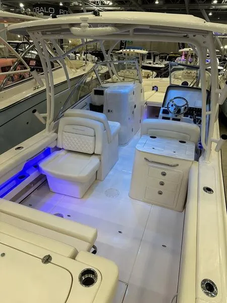 Slide: The Image of 2025 Grady-White Freedom 275 boat interior with seating and blue accent lighting. - 6