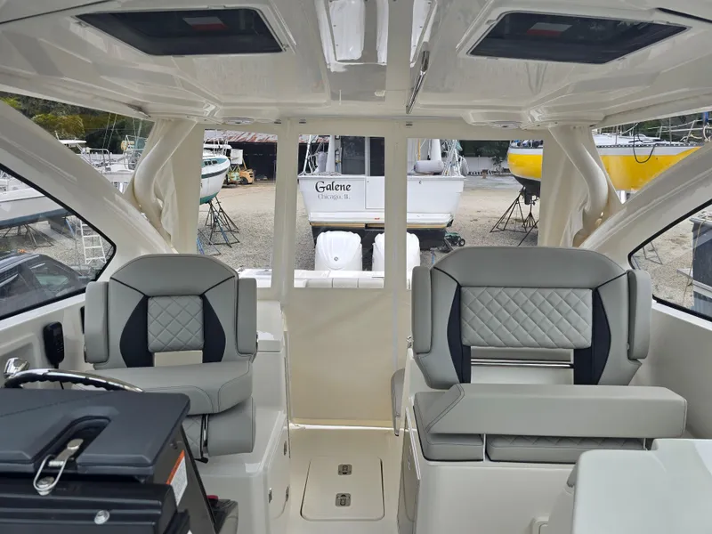 Slide: The Image of 2025 Pursuit DC 306 Dual Console interior with modern seating and sleek design. - 11