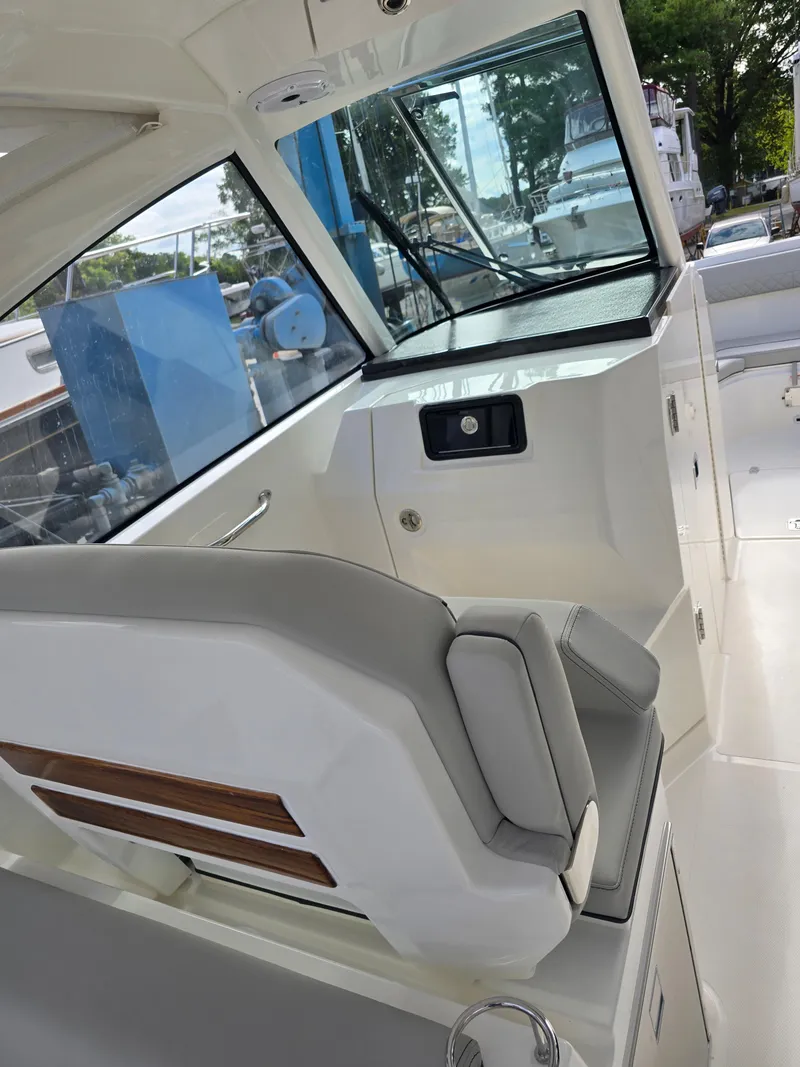 Slide: The Image of 2025 Pursuit DC 306 Dual Console interior with sleek seating and modern design. - 14