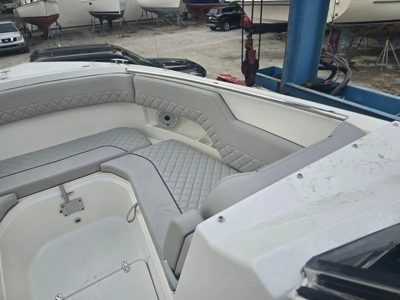 Slide: The Image of 2025 Pursuit DC 306 Dual Console boat interior with cushioned seating. - 20