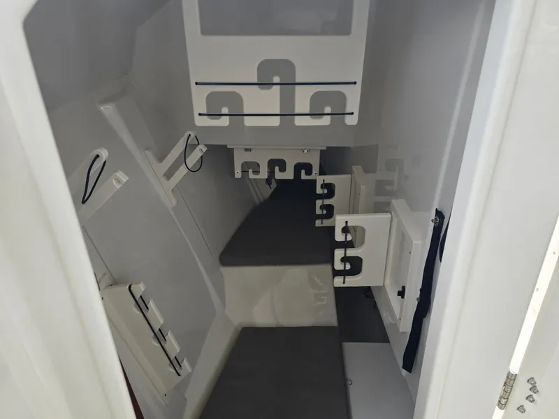 Slide: The Image of Interior cabin of 2025 Pursuit DC 306 Dual Console boat, featuring seating and storage. - 25