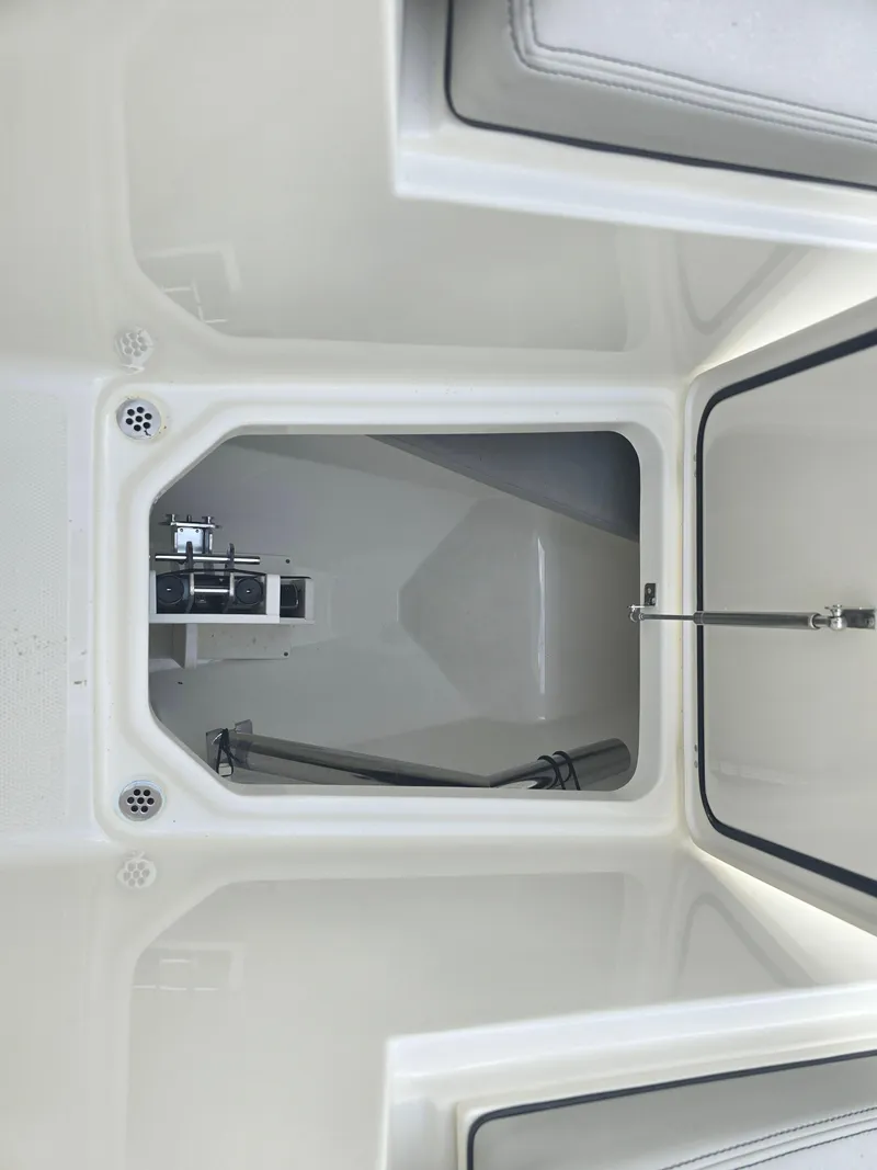 Slide: The Image of 2025 Pursuit DC 306 Dual Console boat storage compartment, open and empty. - 27