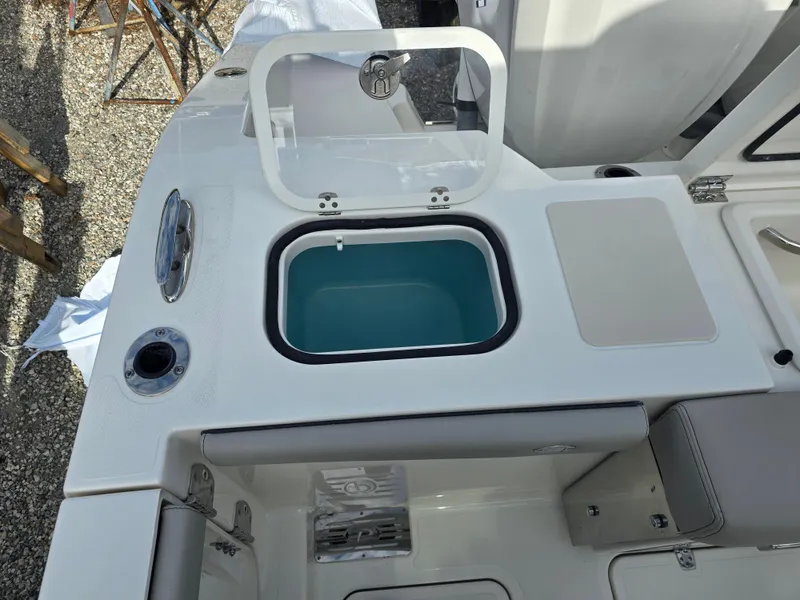 Slide: The Image of 2025 Pursuit DC 306 Dual Console boat with open storage compartment. - 5