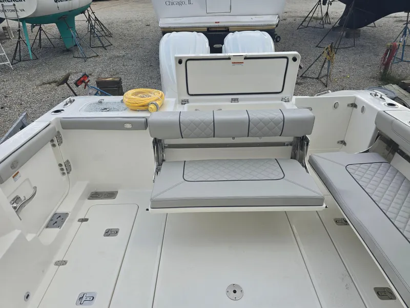 Slide: The Image of 2025 Pursuit DC 306 Dual Console boat interior with foldable seating and storage. - 6