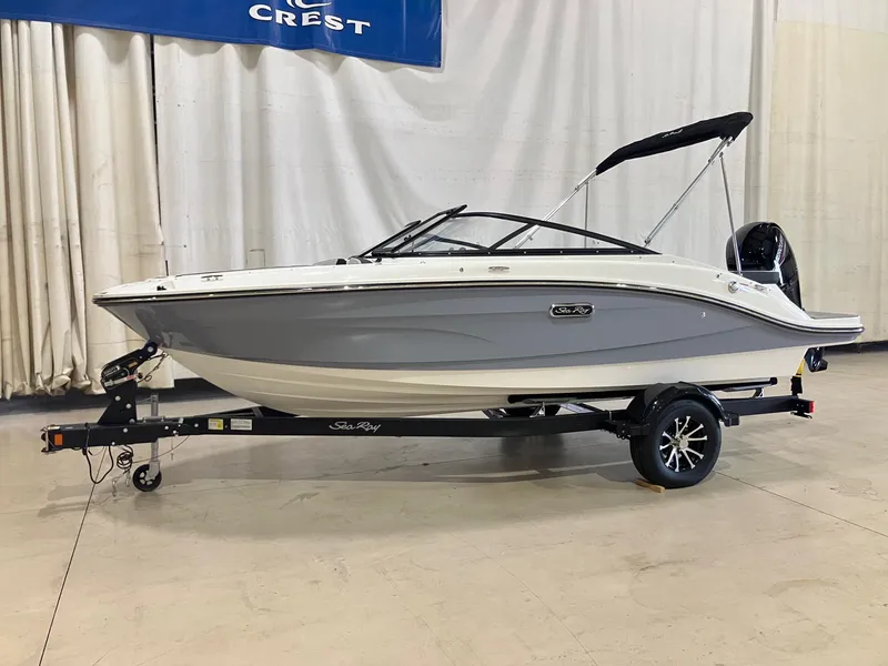 The Image of 2025 Sea Ray SPX 190 Outboard boat on trailer, displayed indoors. - 0