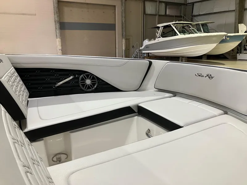 Slide: The Image of 2025 Sea Ray SPX 190 Outboard interior with white seating in a showroom. - 11