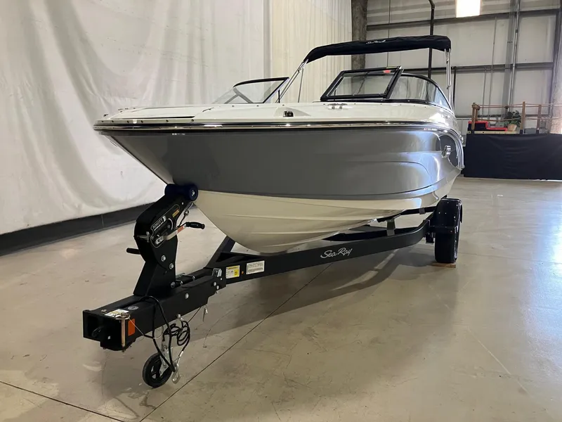 Slide: The Image of 2025 Sea Ray SPX 190 Outboard boat on trailer in indoor setting. - 2