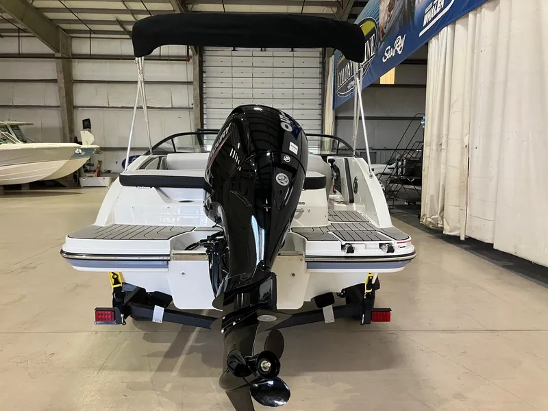Slide: The Image of 2025 Sea Ray SPX 190 Outboard boat in showroom, rear view with motor. - 5