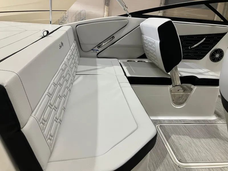 Slide: The Image of 2025 Sea Ray SPX 190 Outboard interior with white seating and modern design. - 8