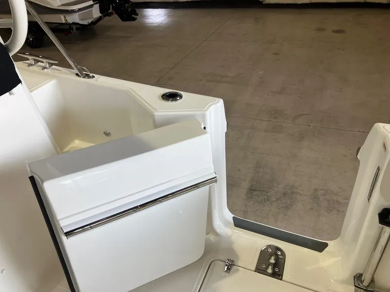 Slide: The Image of 2025 Boston Whaler 325 Conquest boat interior, featuring sleek white seating and deck area. - 10