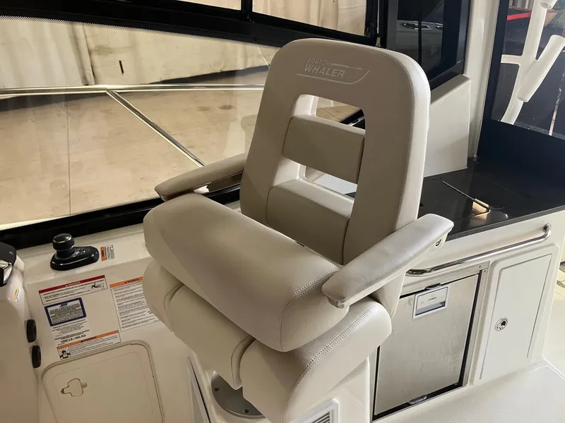 Slide: The Image of Captain's chair on 2025 Boston Whaler 325 Conquest boat, featuring sleek design and comfort. - 13