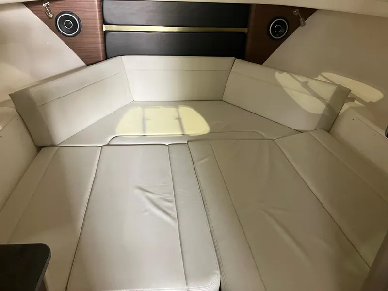 Slide: The Image of Interior cabin of 2025 Boston Whaler 325 Conquest with beige seating and wood accents. - 20
