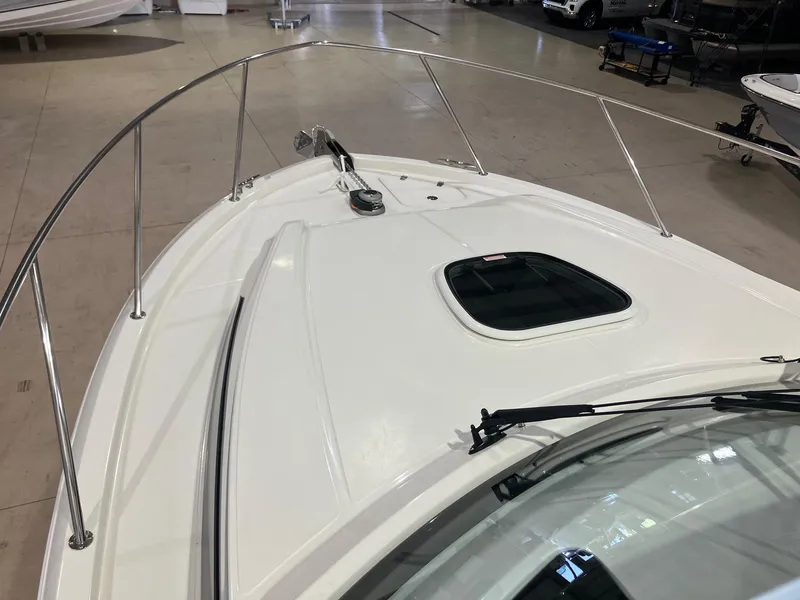 Slide: The Image of 2025 Boston Whaler 325 Conquest boat deck with railing and hatch. - 24