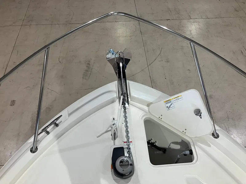 Slide: The Image of 2025 Boston Whaler 325 Conquest bow with anchor and storage compartment. - 26