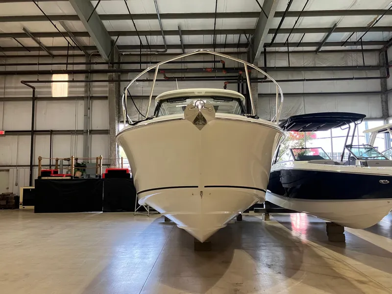 Slide: The Image of 2025 Boston Whaler 325 Conquest boat in a warehouse, front view. - 3