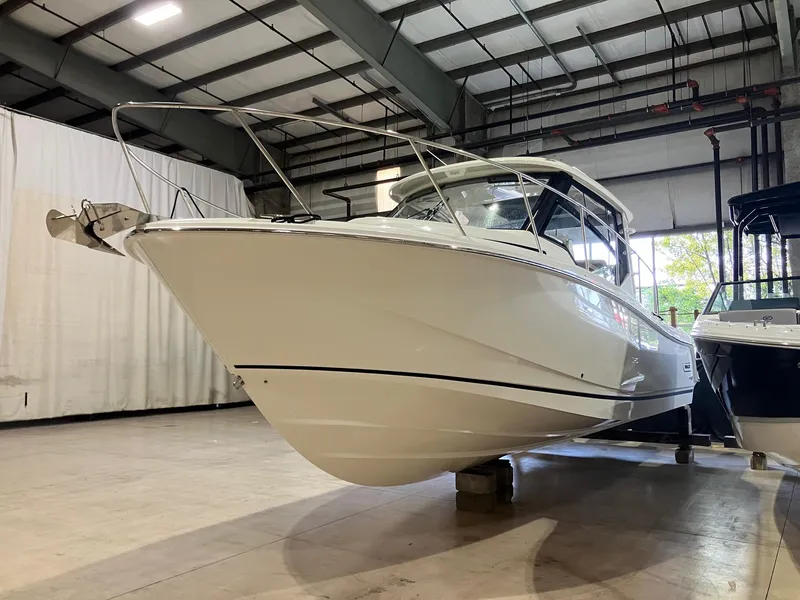 Slide: The Image of 2025 Boston Whaler 325 Conquest boat in indoor storage facility. - 4