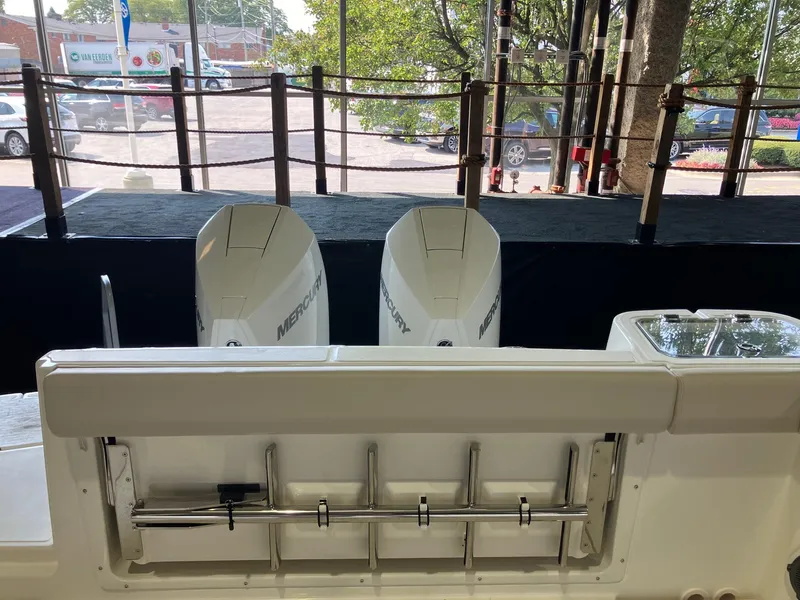 Slide: The Image of 2025 Boston Whaler 325 Conquest with dual Mercury outboard engines, docked outdoors. - 6