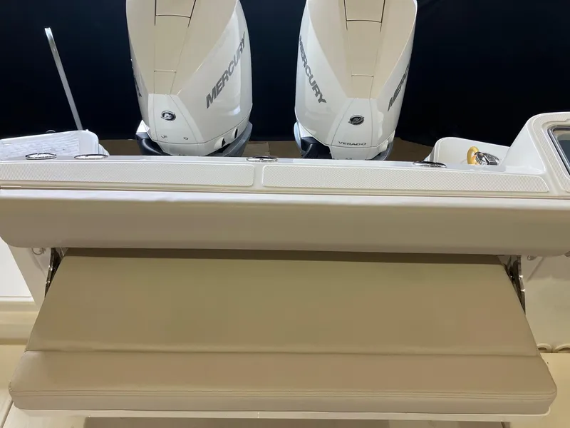 Slide: The Image of 2025 Boston Whaler 325 Conquest with dual Mercury engines and cushioned seating. - 7