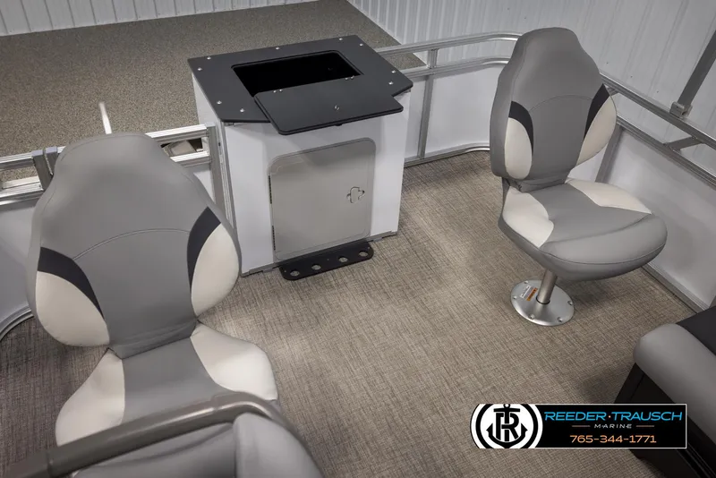 Slide: The Image of Interior of 2025 Avalon VEN RF boat with two gray swivel seats and storage compartment. - 21