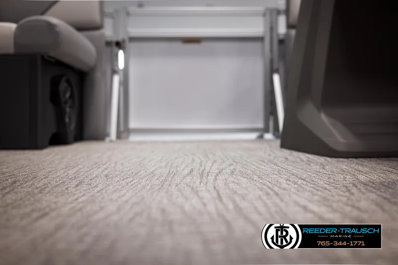 Slide: The Image of Interior view of 2025 Avalon VEN RF boat, featuring carpeted flooring and seating. - 38