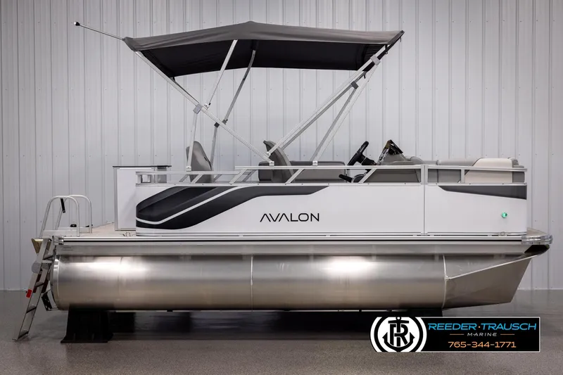 Slide: The Image of 2025 Avalon VEN RF pontoon boat with canopy, displayed indoors at Reeder-Trausch Marine. - 5