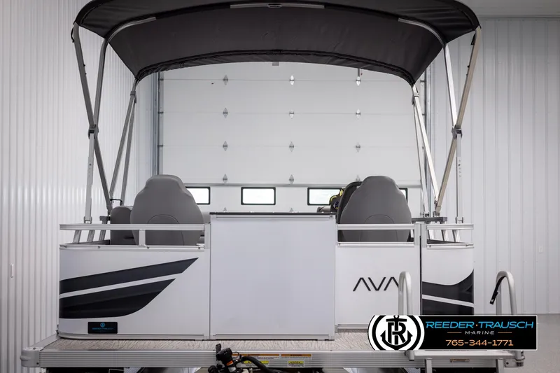 Slide: The Image of 2025 Avalon VEN RF boat in a garage, featuring sleek design and canopy. - 7