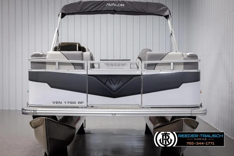 Slide: The Image of 2025 Avalon VEN RF pontoon boat, sleek design, displayed indoors at Reeder-Trausch Marine. - 8