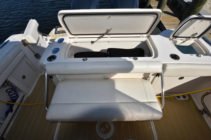 Slide: The Image of 2019 Grady-White Freedom 325 boat with open storage compartment and seating. - 10