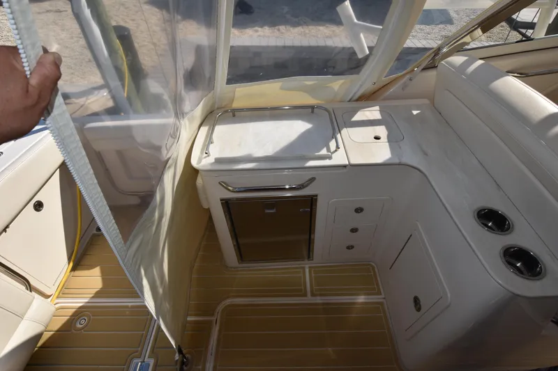 Slide: The Image of 2019 Grady-White Freedom 325 boat interior with kitchenette and seating area. - 11