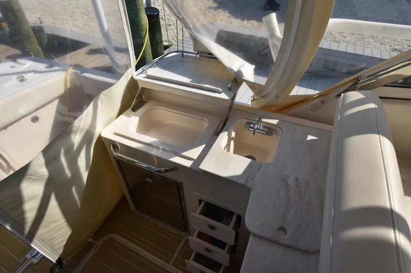 Slide: The Image of 2019 Grady-White Freedom 325 boat interior with sink and storage area. - 12