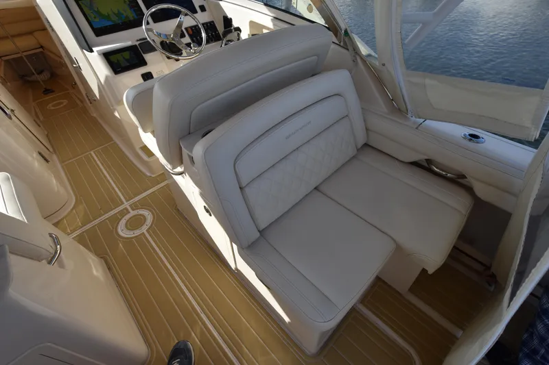 Slide: The Image of Interior of 2019 Grady-White Freedom 325 boat with luxurious seating and modern dashboard. - 13