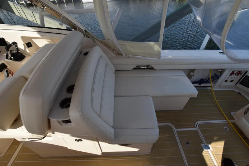 Slide: The Image of 2019 Grady-White Freedom 325 boat interior with beige seating and wooden flooring. - 14