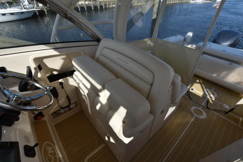 Slide: The Image of 2019 Grady-White Freedom 325 boat interior with helm and seating area. - 16
