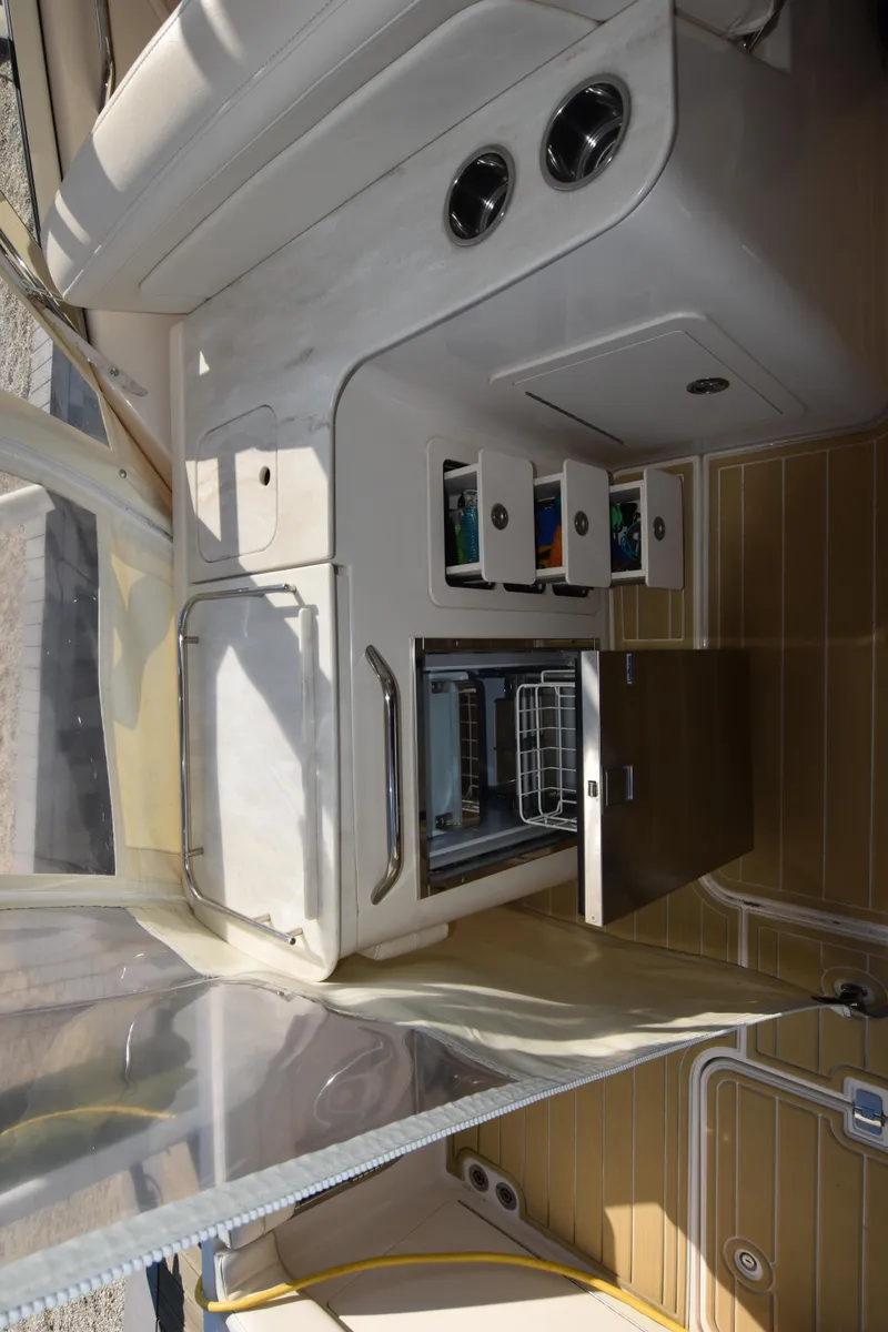 Slide: The Image of 2019 Grady-White Freedom 325 boat interior with storage compartments and appliances. - 22