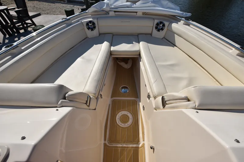 Slide: The Image of 2019 Grady-White Freedom 325 boat interior with beige seating and wood flooring. - 26