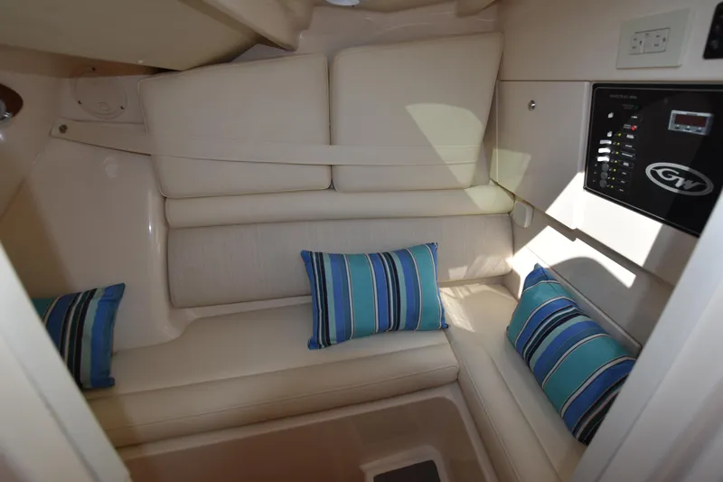 Slide: The Image of 2019 Grady-White Freedom 325 cabin interior with striped cushions and control panel. - 27
