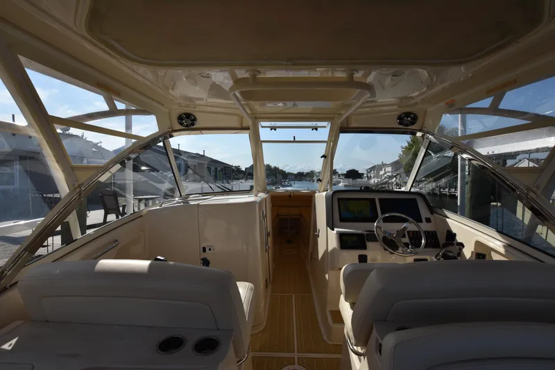 Slide: The Image of Interior view of 2019 Grady-White Freedom 325 boat cockpit with helm and seating. - 29
