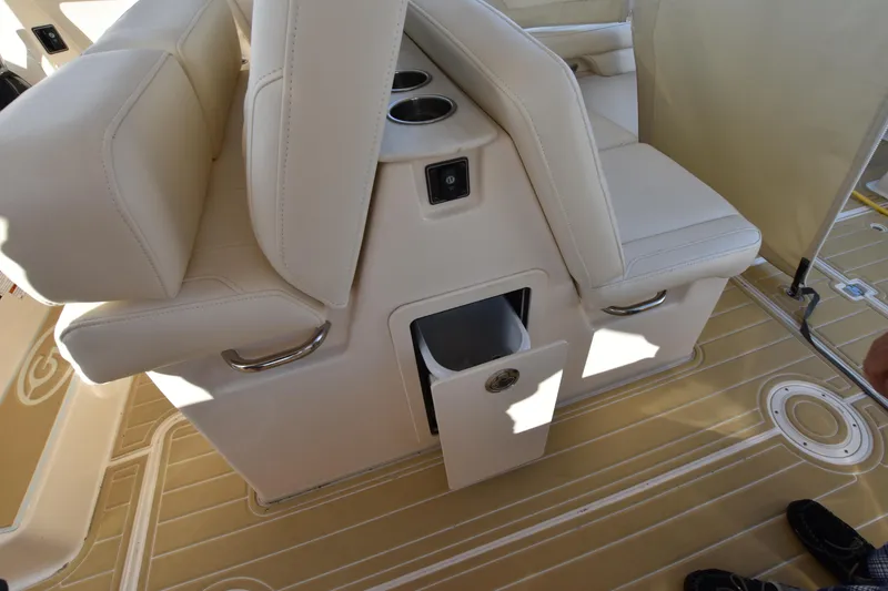 Slide: The Image of 2019 Grady-White Freedom 325 boat interior with beige seating and storage compartment. - 36