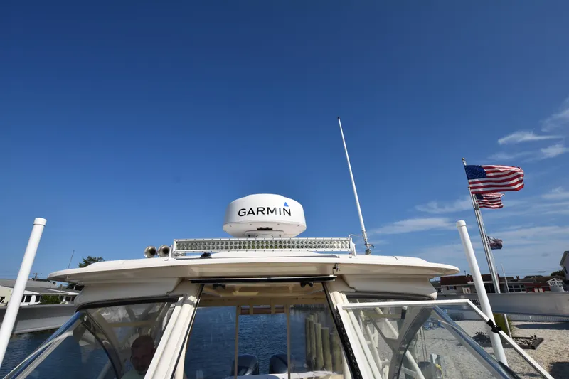 Slide: The Image of 2019 Grady-White Freedom 325 boat with Garmin radar, American flag in background. - 39