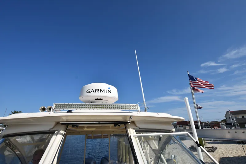 Slide: The Image of 2019 Grady-White Freedom 325 boat with Garmin radar, American flag in background. - 40