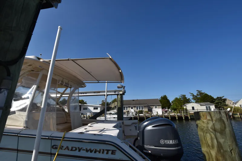 Slide: The Image of 2019 Grady-White Freedom 325 boat docked with Yamaha engine, clear blue sky. - 43