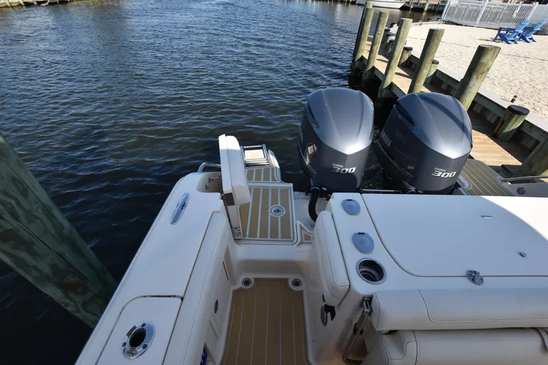 Slide: The Image of 2019 Grady-White Freedom 325 boat with twin 300 horsepower engines docked by the water. - 6
