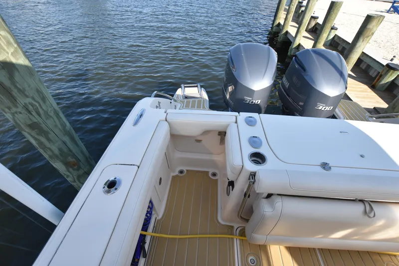 Slide: The Image of 2019 Grady-White Freedom 325 boat with twin engines docked by the water. - 7