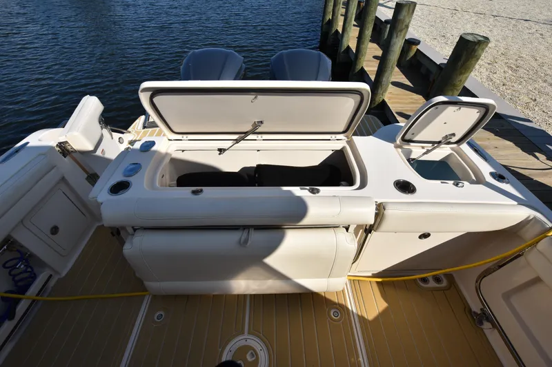 Slide: The Image of 2019 Grady-White Freedom 325 boat with open storage compartments at dock. - 9