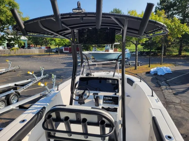 Slide: The Image of 2025 Edgewater 208 WATCHMAN boat with T-top and console in a parking lot. - 13